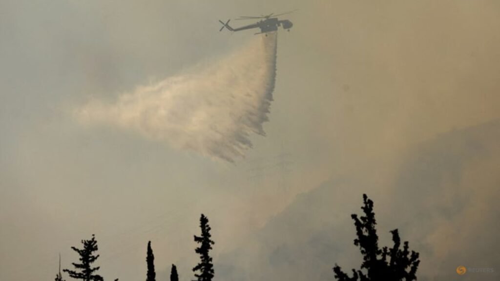 Firefighters in Greece struggle to save coastal resort as winds rage